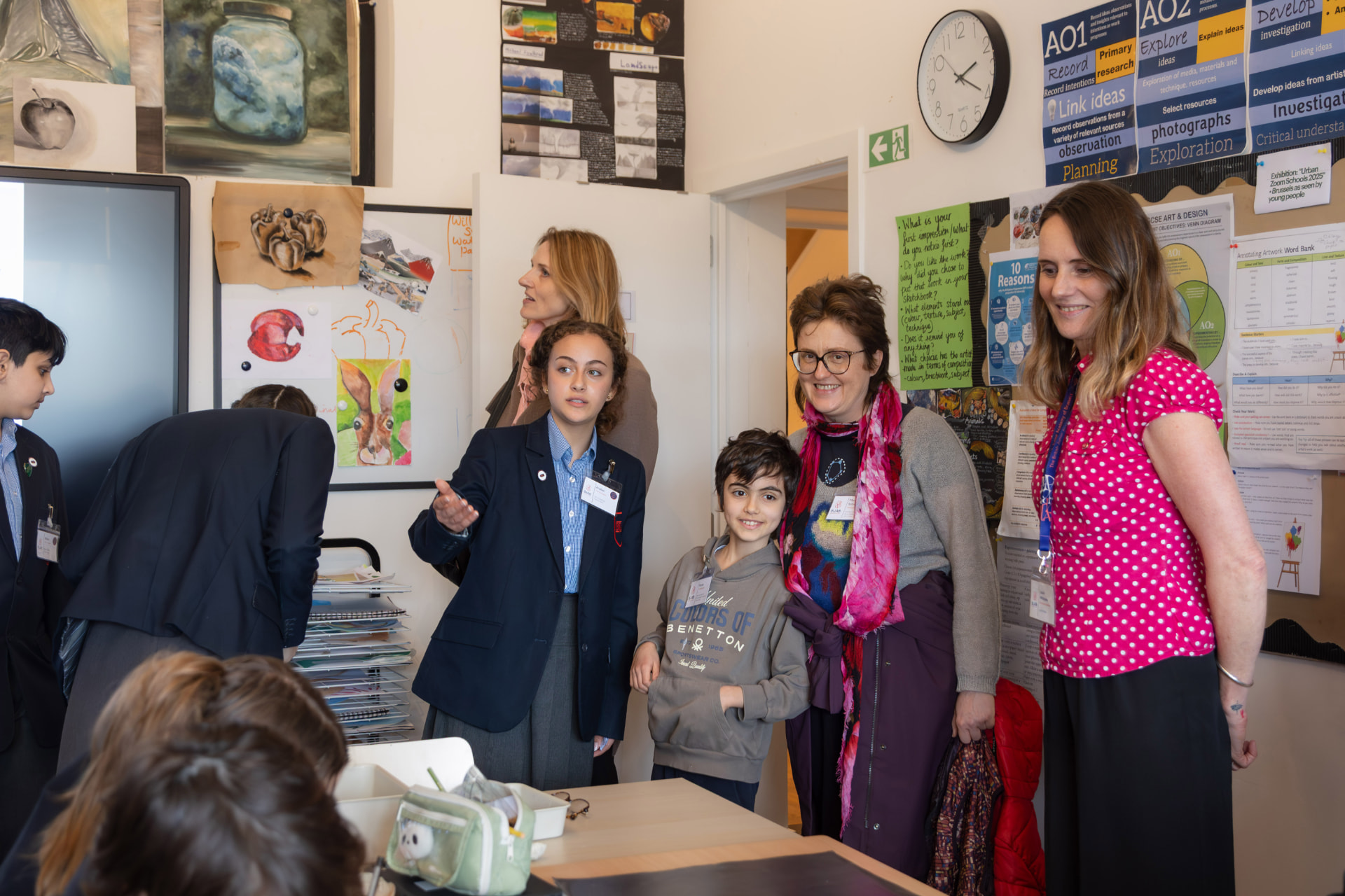 A BJAB student showing visitors around an art classroom